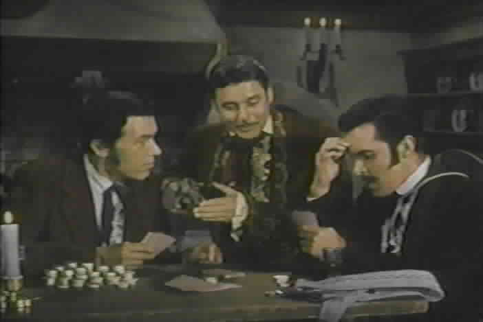 Don Diego tries to distract Urista and Ramon while they play cards.