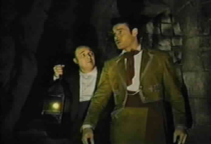 Don Diego shows Bernardo the passage to Zorro's secret cave.