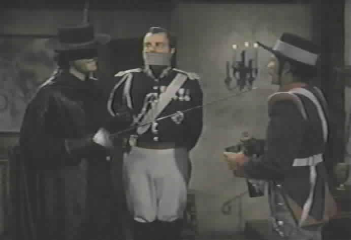 Zorro tries to force Figueroa into telling Toledano the truth about the plot.
