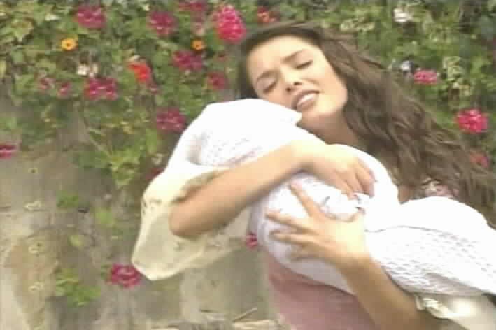 Esmeralda embraces her baby.